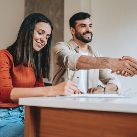 Couple signing paperwork