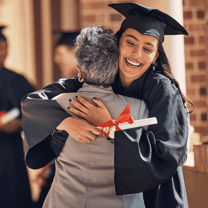 Girl hugs woman at graduation