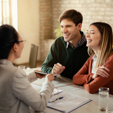 Signing mortgage paperwork smiling