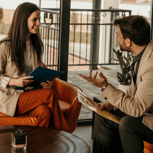 Woman and Man Happily Discussing Paperwork