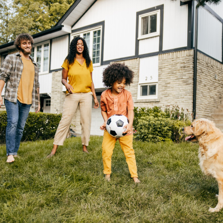 family-playing-outside-with-dog