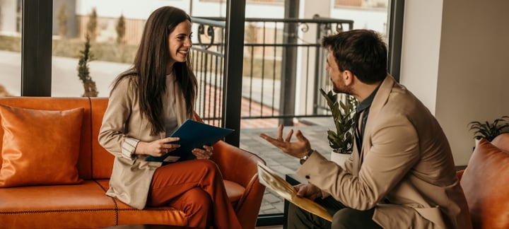 woman and man discussing in office