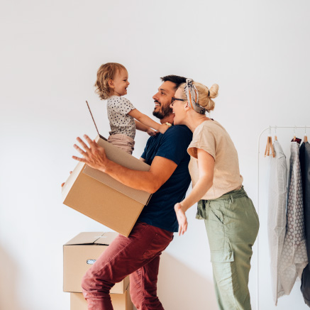 Young-couple-with-child-coming-out-of-box